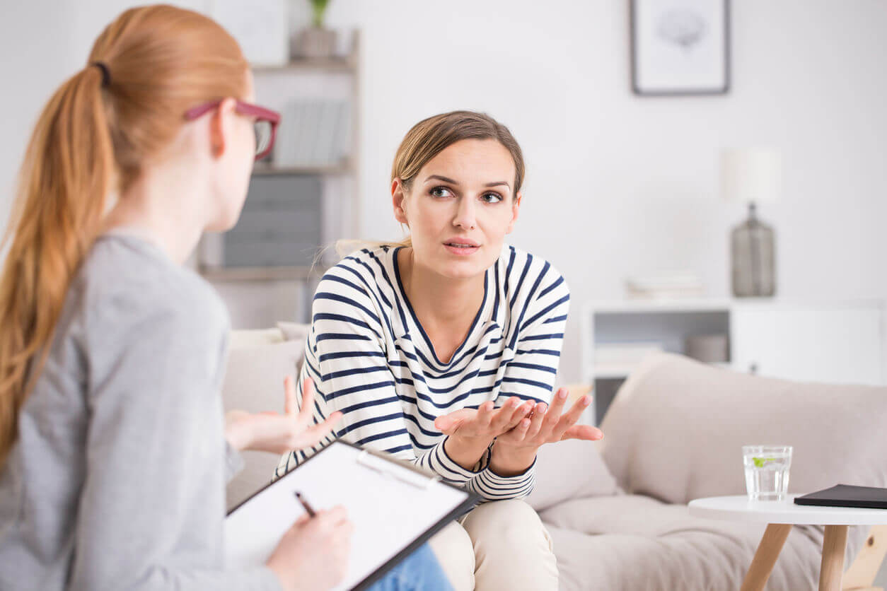 A female patient is undergoing therapy sessions with a female therapist for her anxiety treatment plan after experiencing traumatic events.