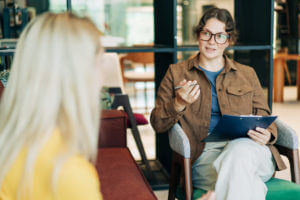 A mental health professional talking to her patient about ADHD testing.