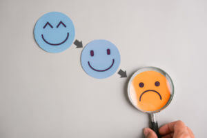 Sad face following happy, emotional down, mental struggle, mood swing, and psychological imbalance in life transitions.