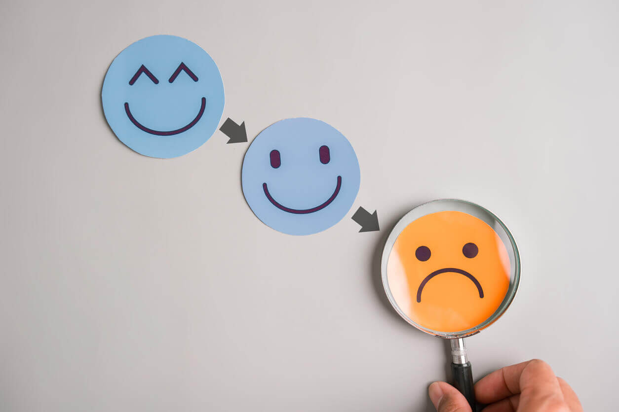Sad face following happy, emotional down, mental struggle, mood swing, and psychological imbalance in life transitions.