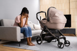 Depressed Unhappy African American Woman With Newborn Is Going Through Postpartum Depression.